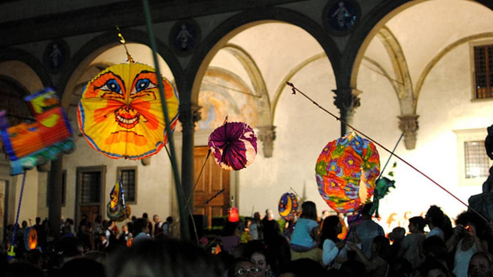 Colorful paper lanterns during the Festa della Rificolona parade in Piazza Santissima Annunziata, Florence.